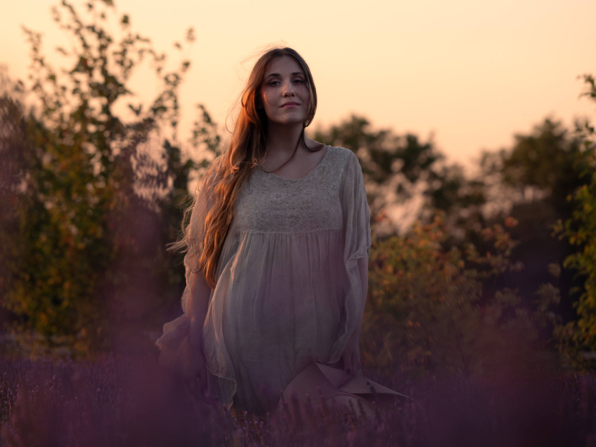 A woman in soft evening light among lavender