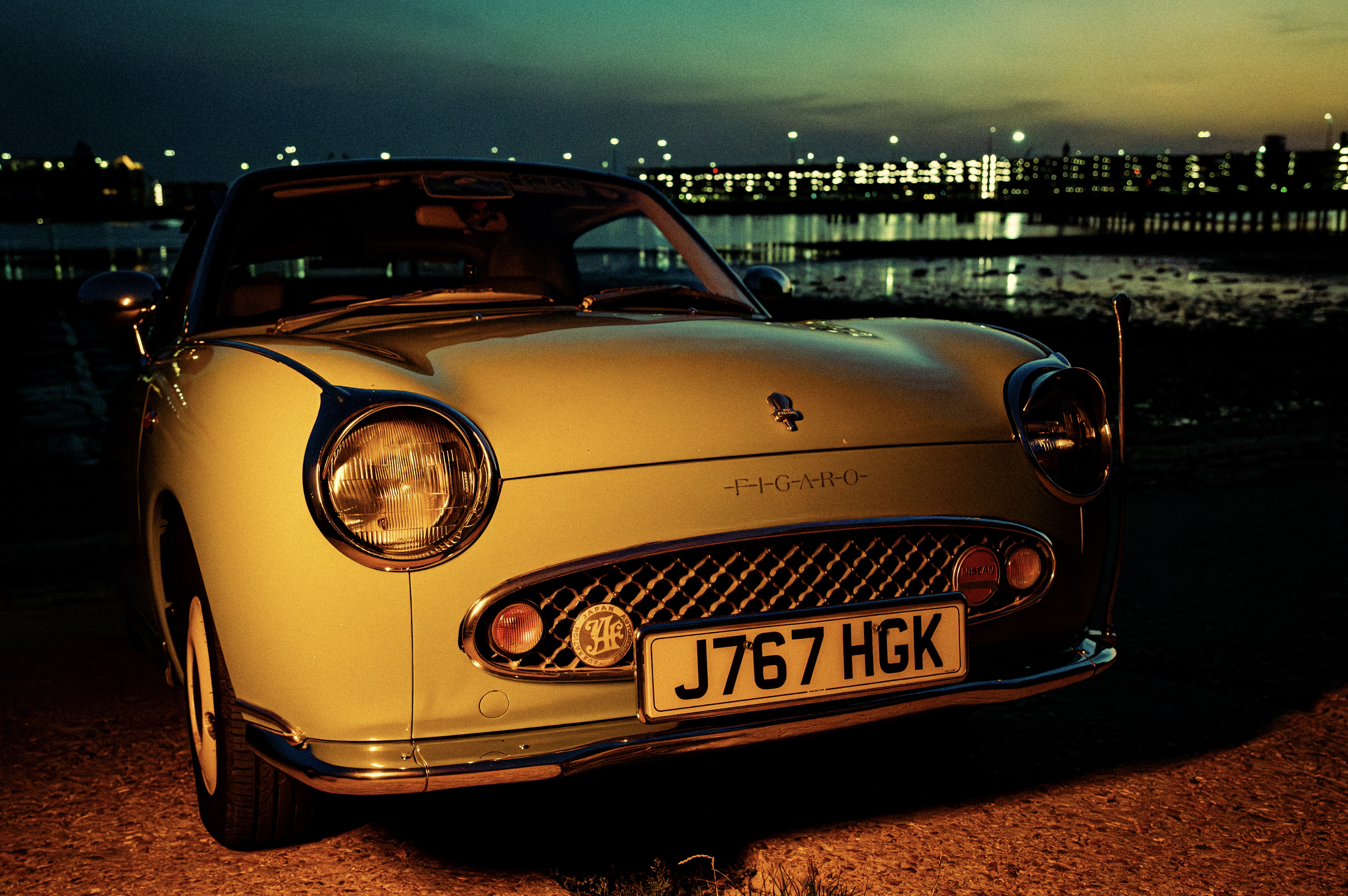 Close-up of Nissan Figaro wheel and chrome trim with creative lighting