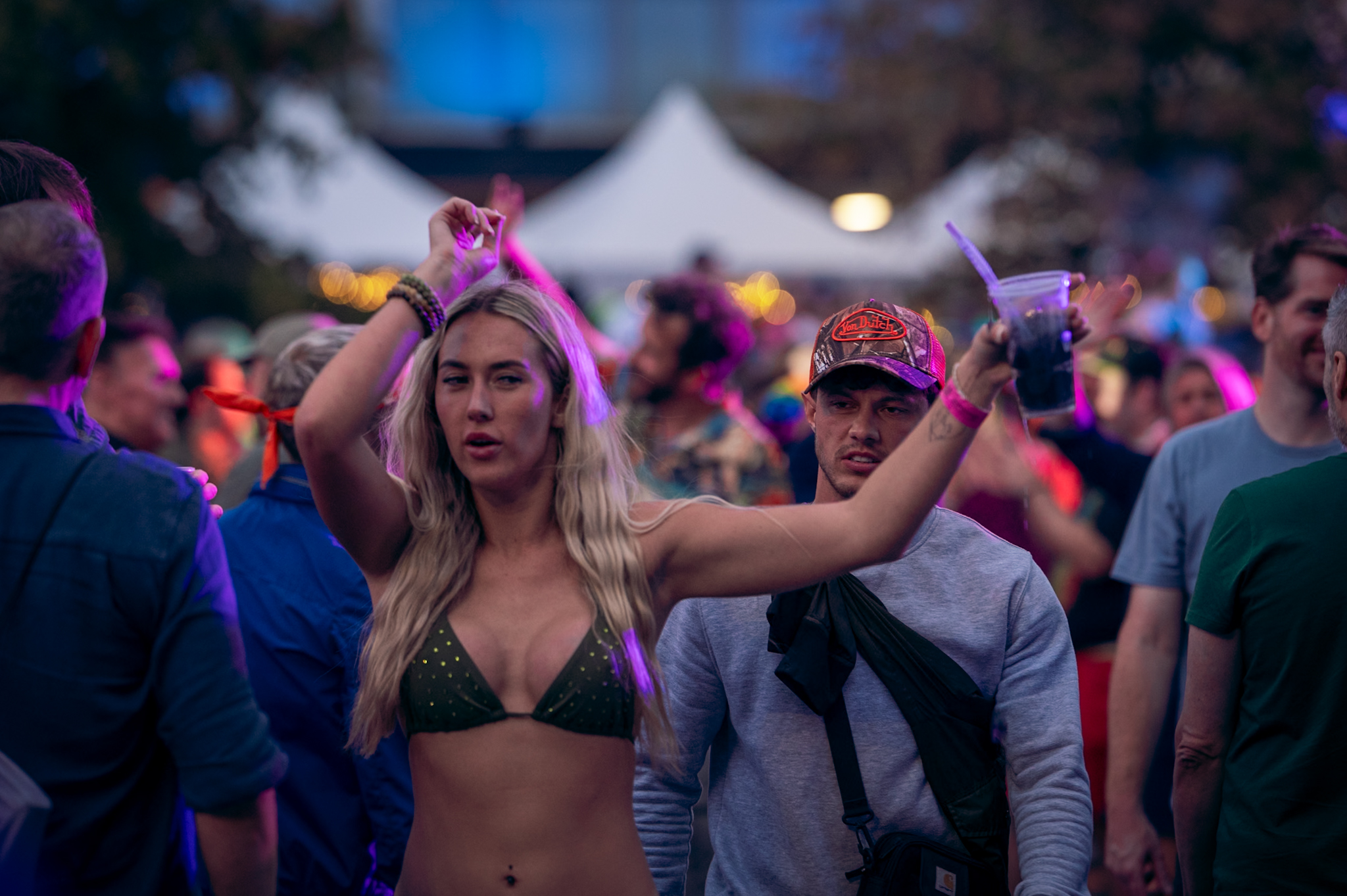People dancing in colourful evening light